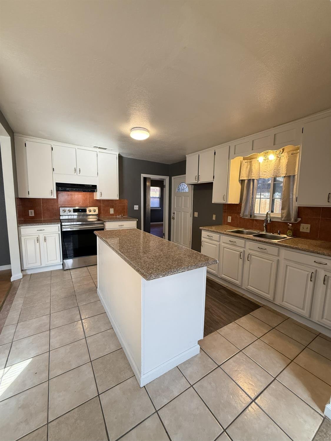 405 Colorado Avenue Modesto, CA 95351 - Photo 13 of 33 a large kitchen with cabinets and stainless steel appliances