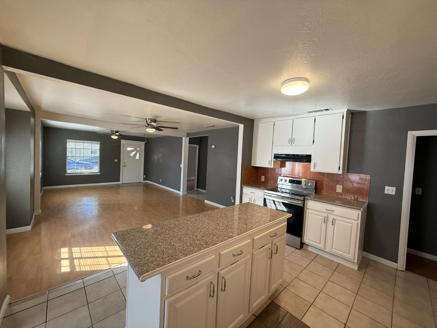 405 Colorado Avenue Modesto, CA 95351 - Photo 14 of 33 a kitchen with stainless steel appliances granite countertop a stove a sink dishwasher and a refrigerator