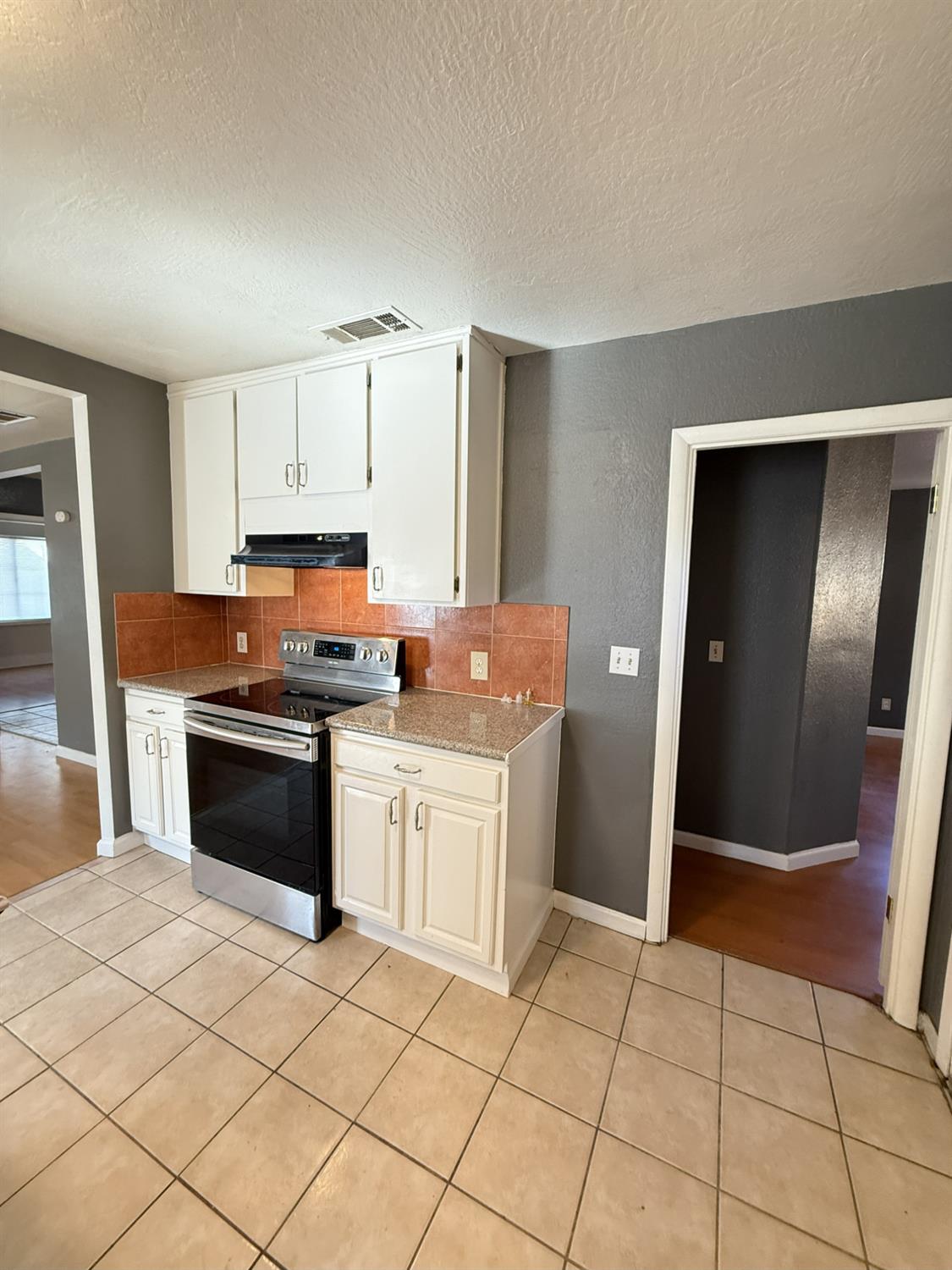 405 Colorado Avenue Modesto, CA 95351 - Photo 15 of 33 a kitchen with stainless steel appliances granite countertop a stove a sink and a microwave