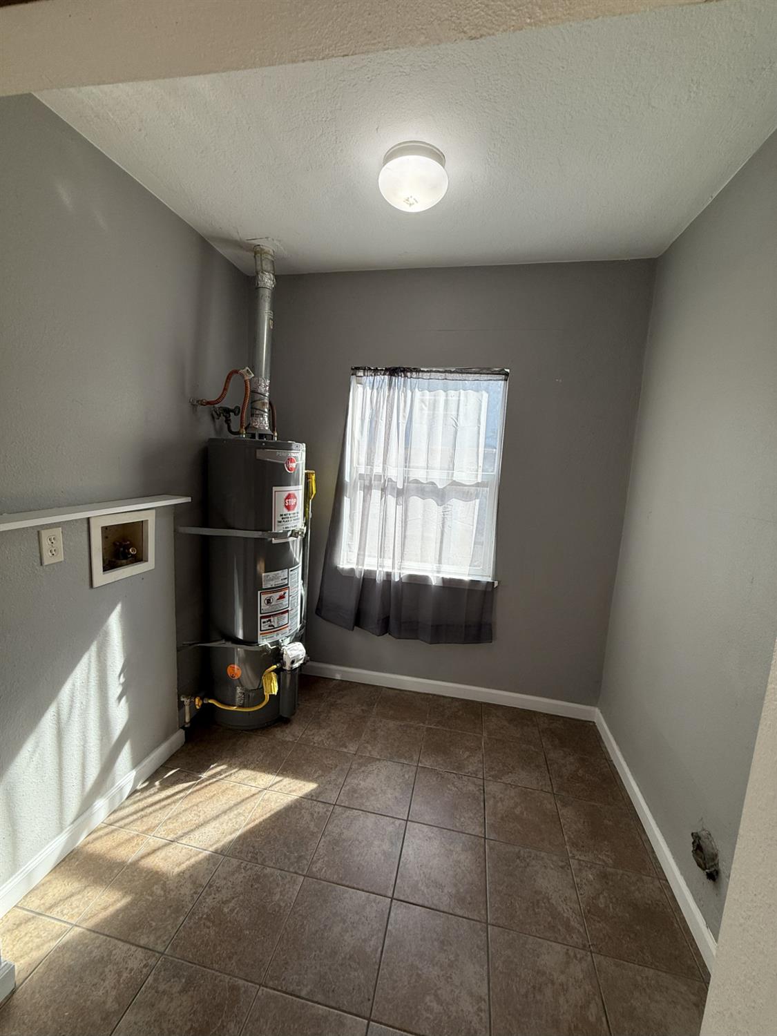405 Colorado Avenue Modesto, CA 95351 - Photo 16 of 33 a view of empty room with a fireplace and windows