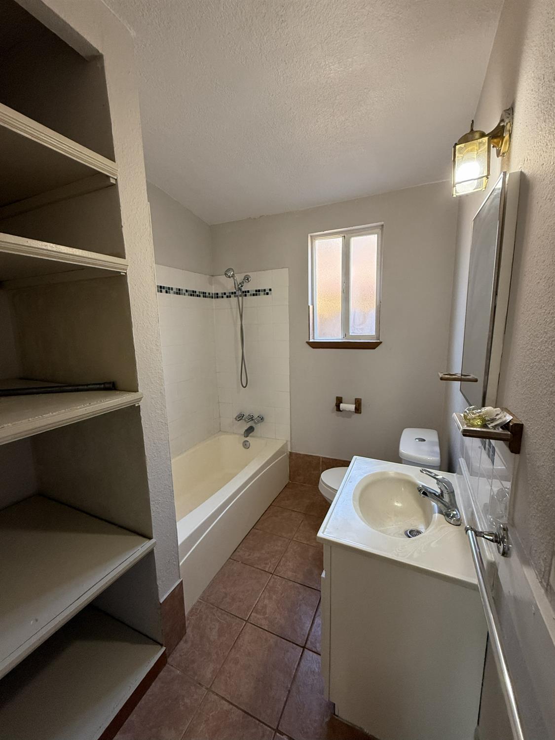 405 Colorado Avenue Modesto, CA 95351 - Photo 19 of 33 a bathroom with a bathtub sink and mirror