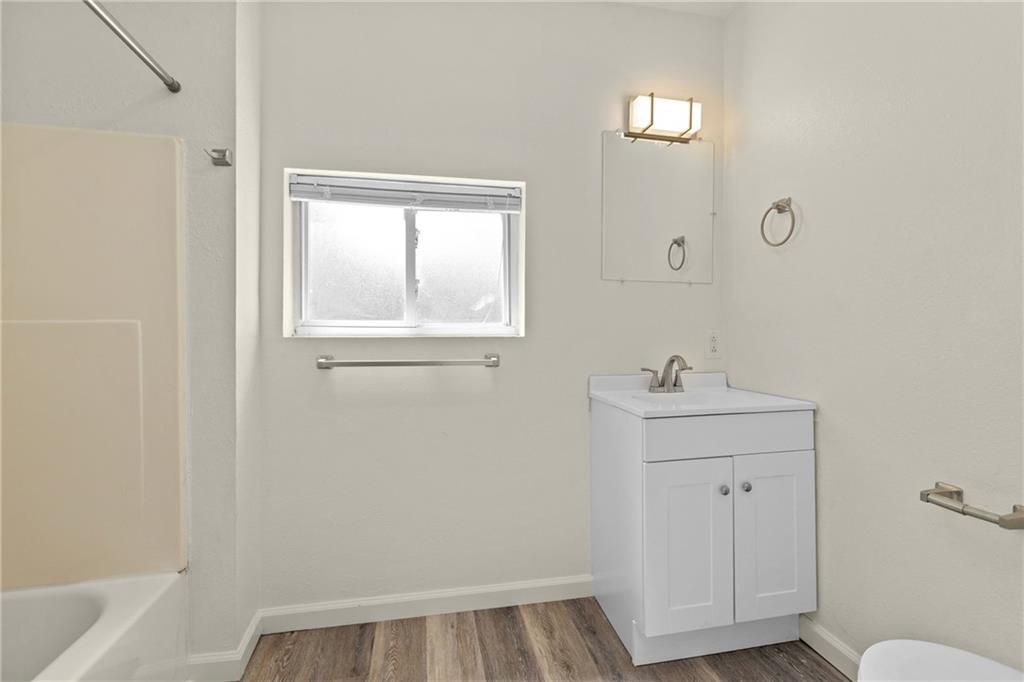 390 Highway 30, Unit B Imperial, PA 15126 - Photo 11 of 13 a view of bathroom with a sink window and wooden floor