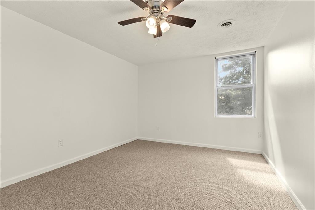 390 Highway 30, Unit B Imperial, PA 15126 - Photo 12 of 13 an empty room with windows and fan