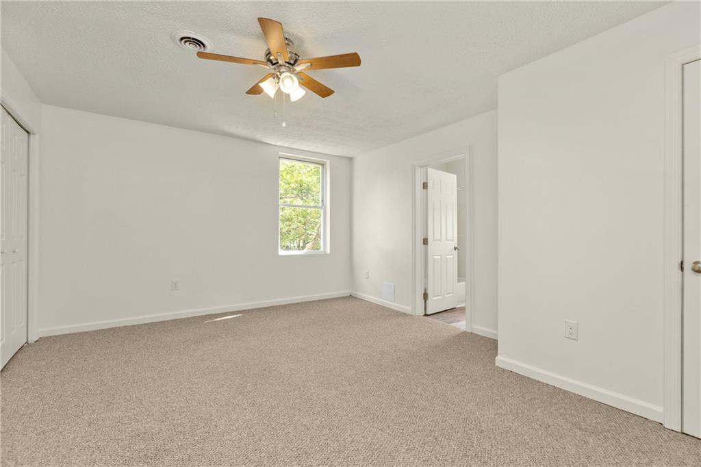 390 Highway 30, Unit B Imperial, PA 15126 - Photo 10 of 13 an empty room with a window and a fan