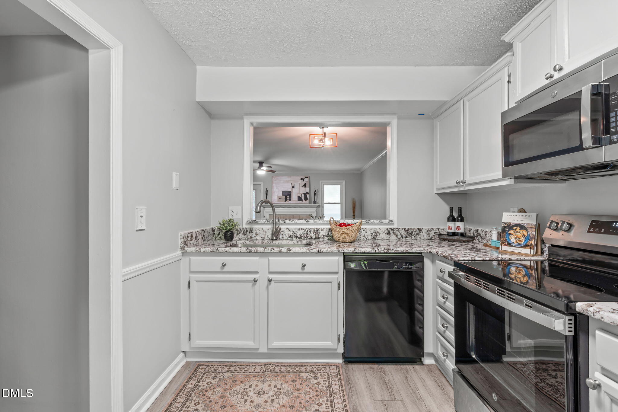 203 Oak Hollow Court Raleigh, NC 27613 - Photo 7 of 37 a kitchen with stainless steel appliances granite countertop a sink and stove top oven