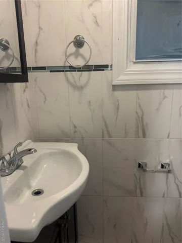 a bathroom with a sink and mirror