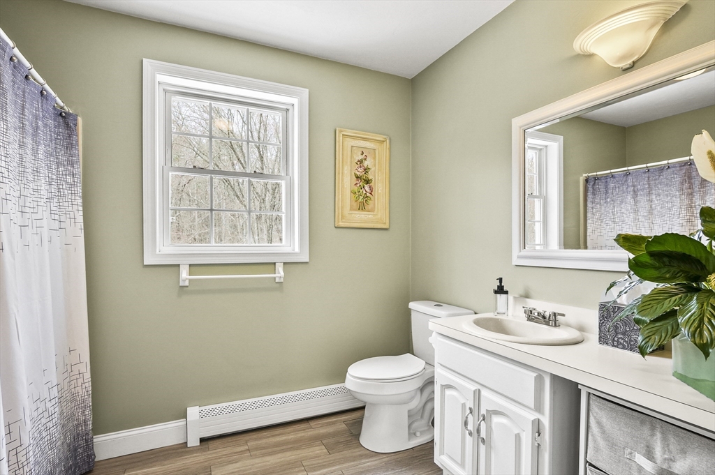 173 Oakham Road North Brookfield, MA 01535 - Photo 23 of 30 a bathroom with a toilet sink and mirror