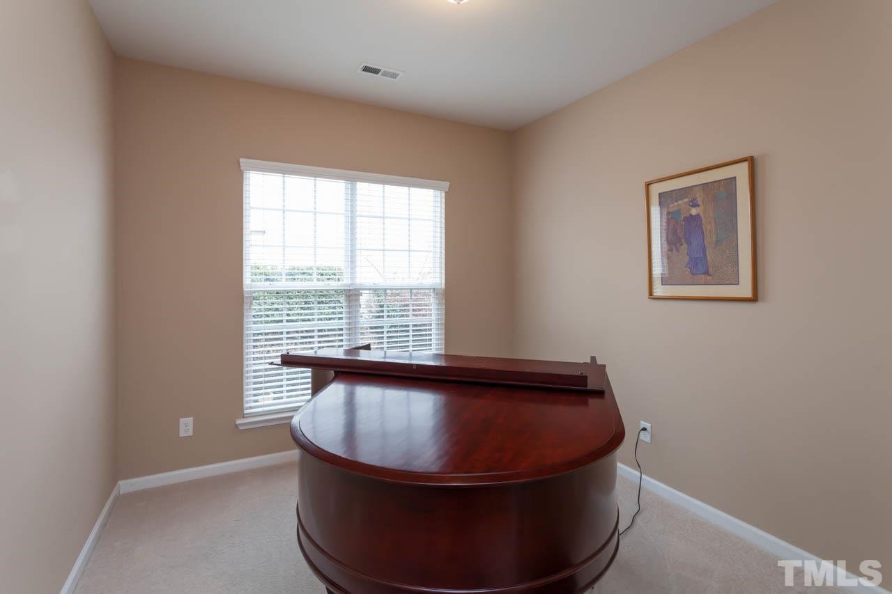7472 Silver View Lane Raleigh, NC 27613 - Photo 12 of 25 a room with a chair and window