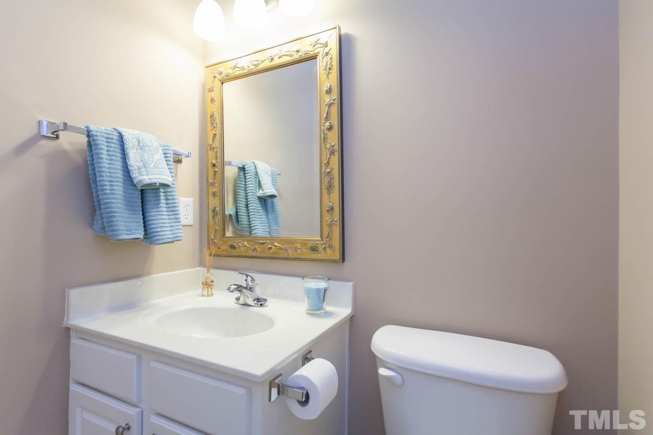7472 Silver View Lane Raleigh, NC 27613 - Photo 13 of 25 a bathroom with a toilet sink and mirror
