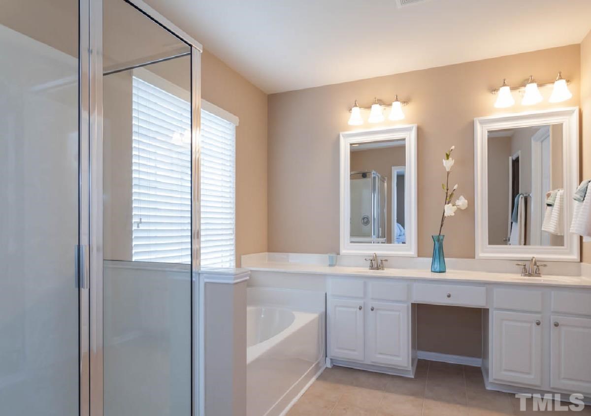 7472 Silver View Lane Raleigh, NC 27613 - Photo 15 of 25 a bathroom with a granite countertop sink and a mirror