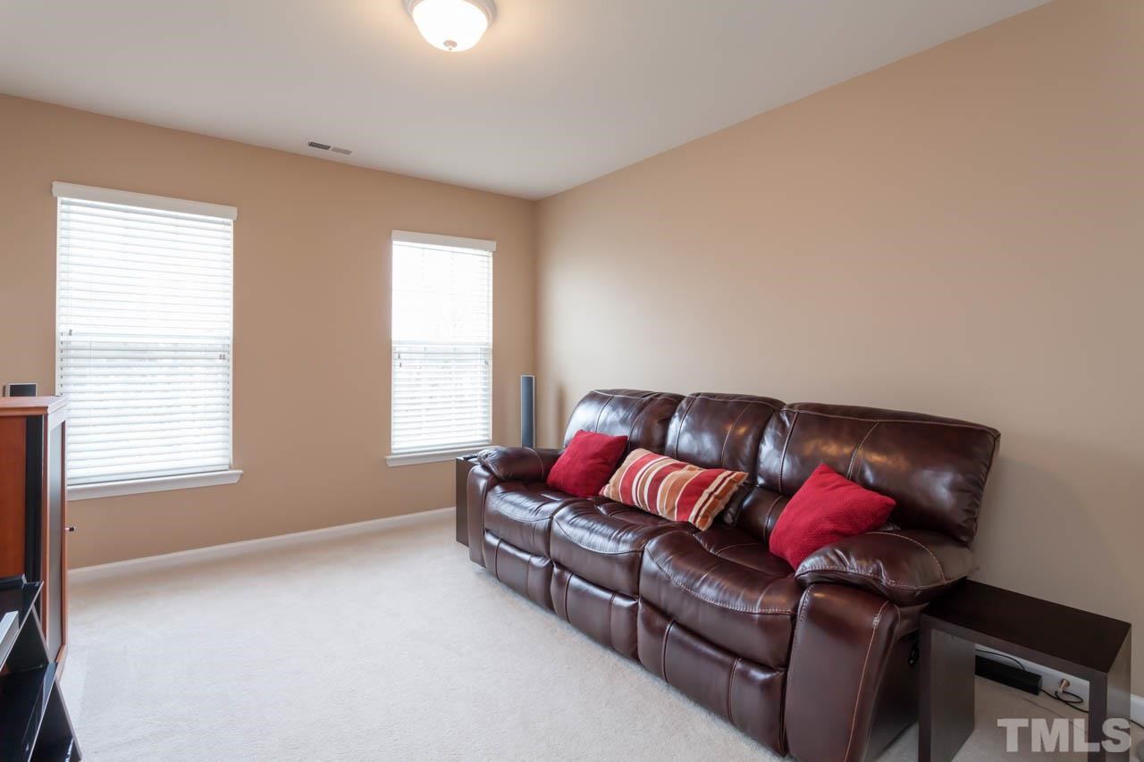 7472 Silver View Lane Raleigh, NC 27613 - Photo 17 of 25 a living room with furniture cabinets and a window