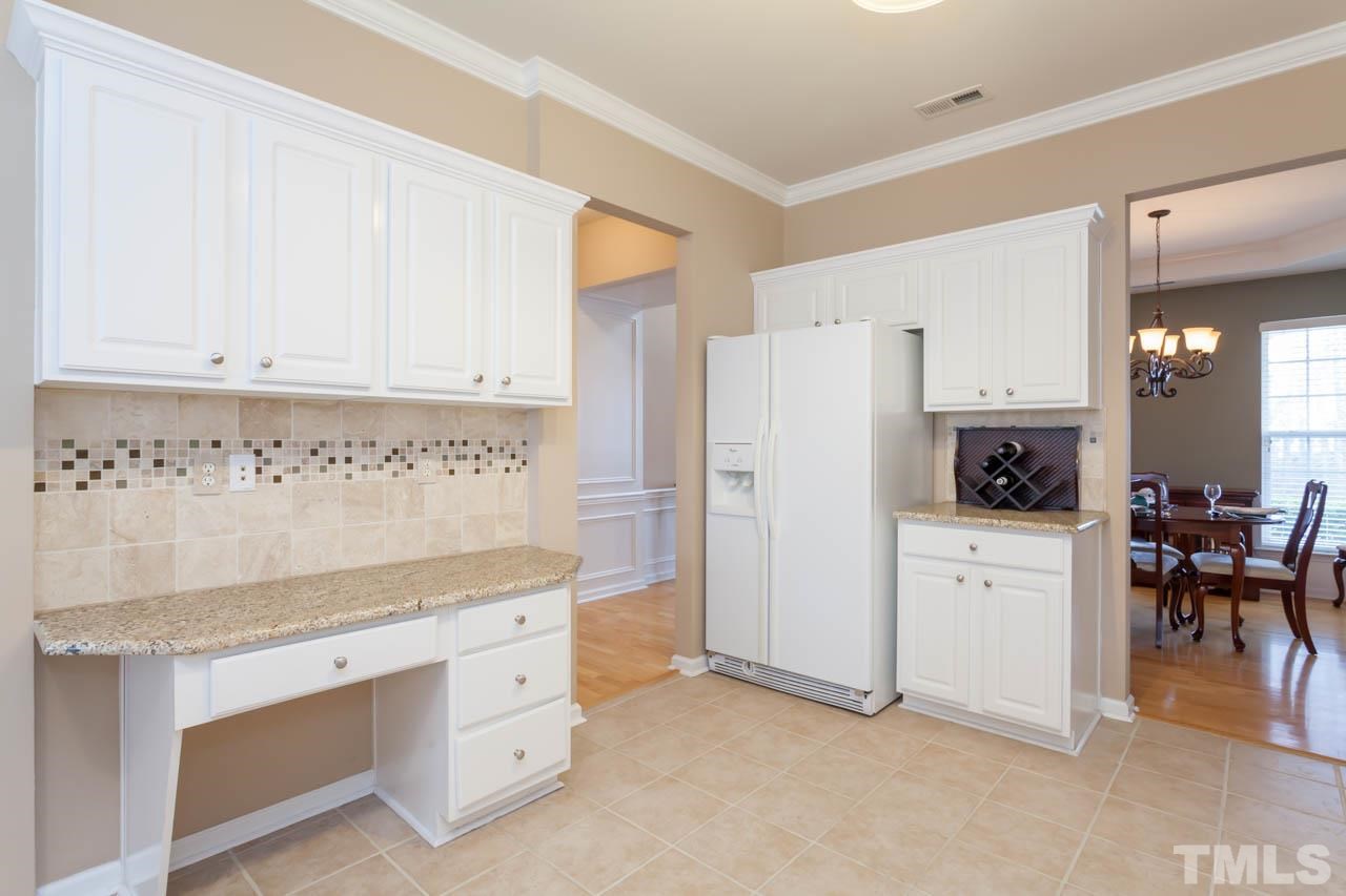 7472 Silver View Lane Raleigh, NC 27613 - Photo 6 of 25 a kitchen with white cabinets and white appliances