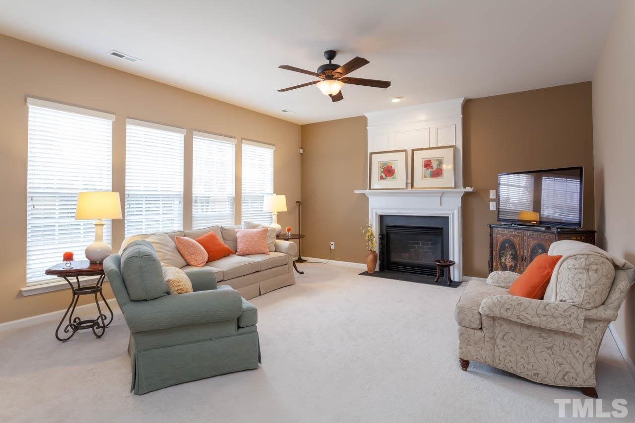 7472 Silver View Lane Raleigh, NC 27613 - Photo 9 of 25 a living room with furniture and a fireplace