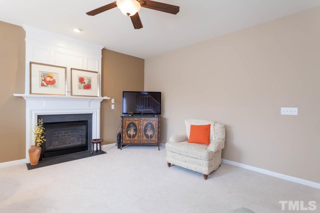 7472 Silver View Lane Raleigh, NC 27613 - Photo 10 of 25 a living room with furniture and a fireplace