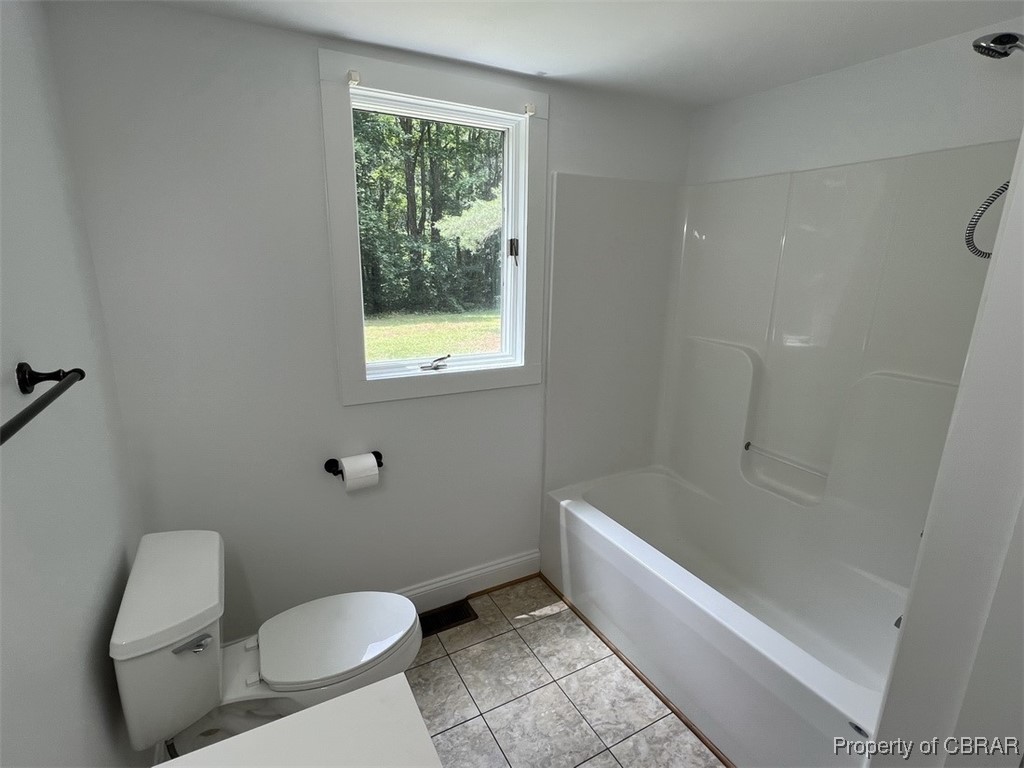 398 Philpot Road Locust Hill, VA 23092 - Photo 9 of 17 Bathroom with toilet, baseboards, and shower / washtub combination