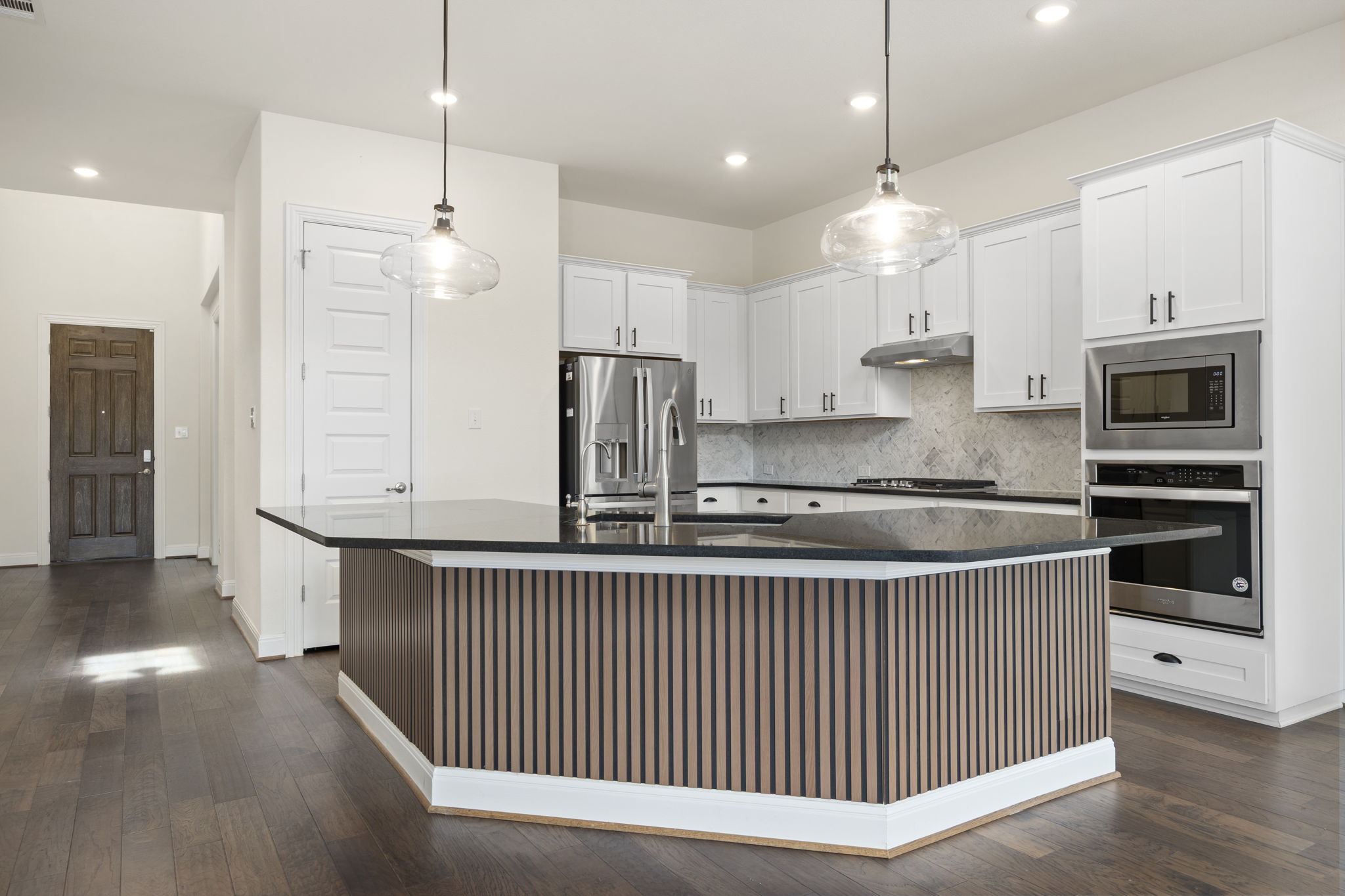 1098 Cherrystone Loop Buda, TX 78610 - Photo 5 of 37 a kitchen with stainless steel appliances kitchen island granite countertop a stove a refrigerator a sink and a oven
