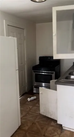 a kitchen with a refrigerator and a stove