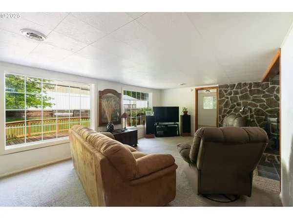 a living room with furniture and chandelier
