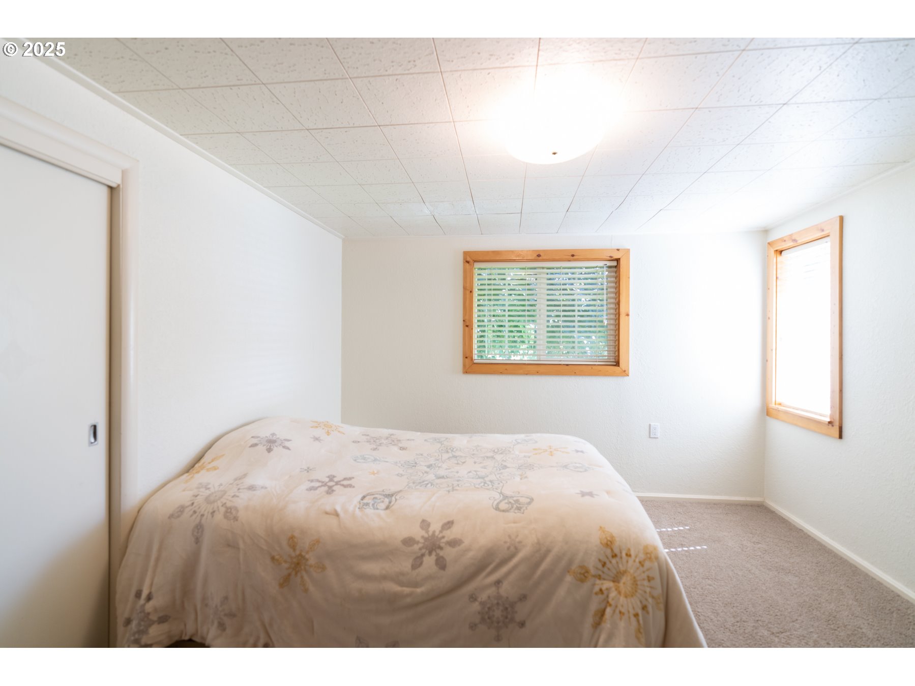 77690 Brock Road Oakridge, OR 97463 - Photo 28 of 45 a bedroom with a bed and a window