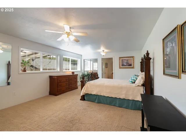 a bedroom with a large bed and a chandelier