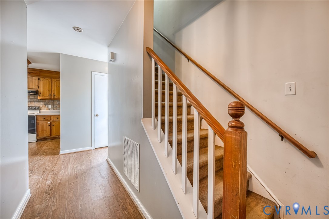 9301 Brocket Drive Midlothian, VA 23112 - Photo 5 of 27 a view of an entryway with wooden floor and stairs