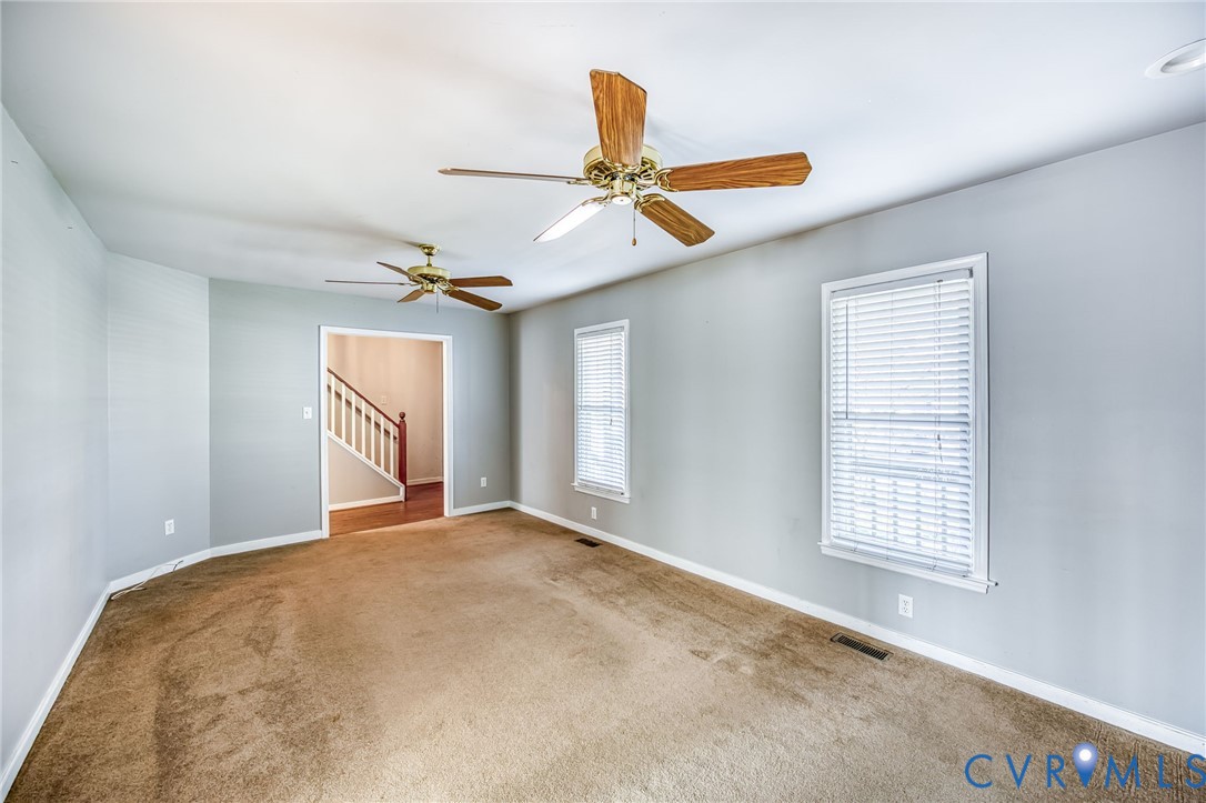 9301 Brocket Drive Midlothian, VA 23112 - Photo 9 of 27 an empty room with windows and fan