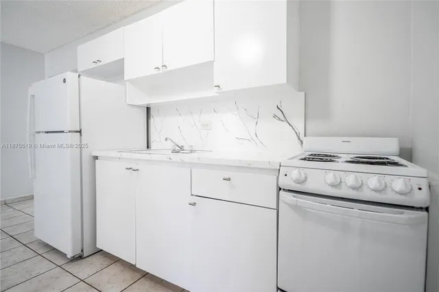a kitchen with appliances and cabinets