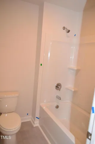a bathroom with a bathtub and a toilet