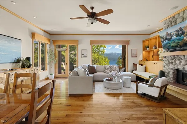 a living room with fireplace furniture and a large window