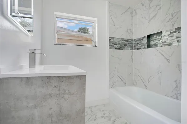 a bathroom with a bathtub and a sink