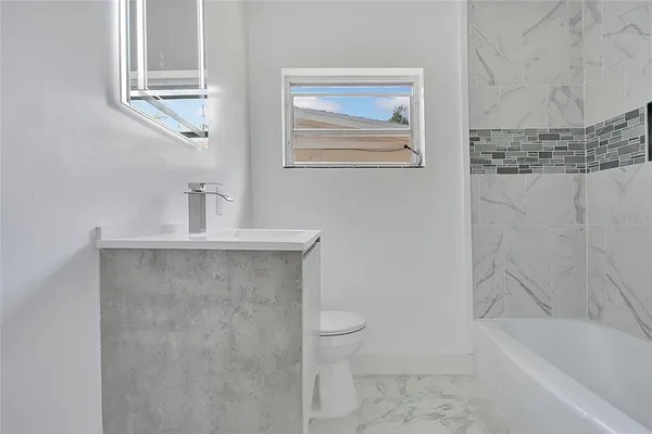 a bathroom with a sink a toilet and bathtub