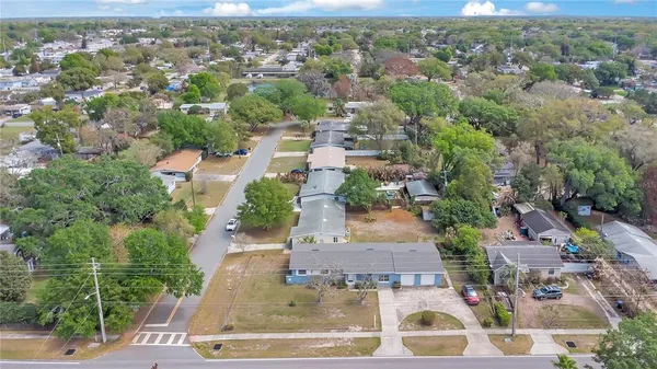 an aerial view of residential houses with outdoor space and lake view