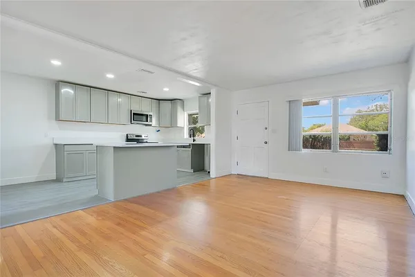 a view of a kitchen with microwave and cabinets