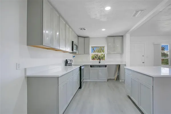a large kitchen with a lot of counter space and a sink