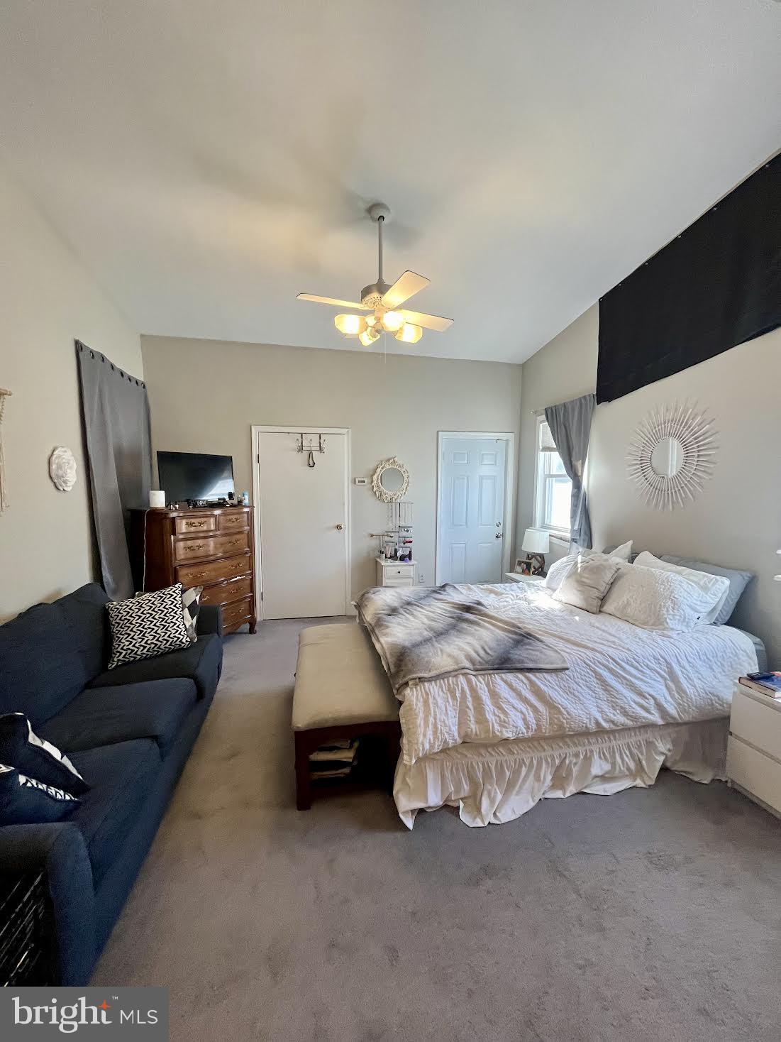 125 Maple Street Conshohocken, PA 19428 - Photo 16 of 32 a spacious bedroom with a bed couch chandelier and windows