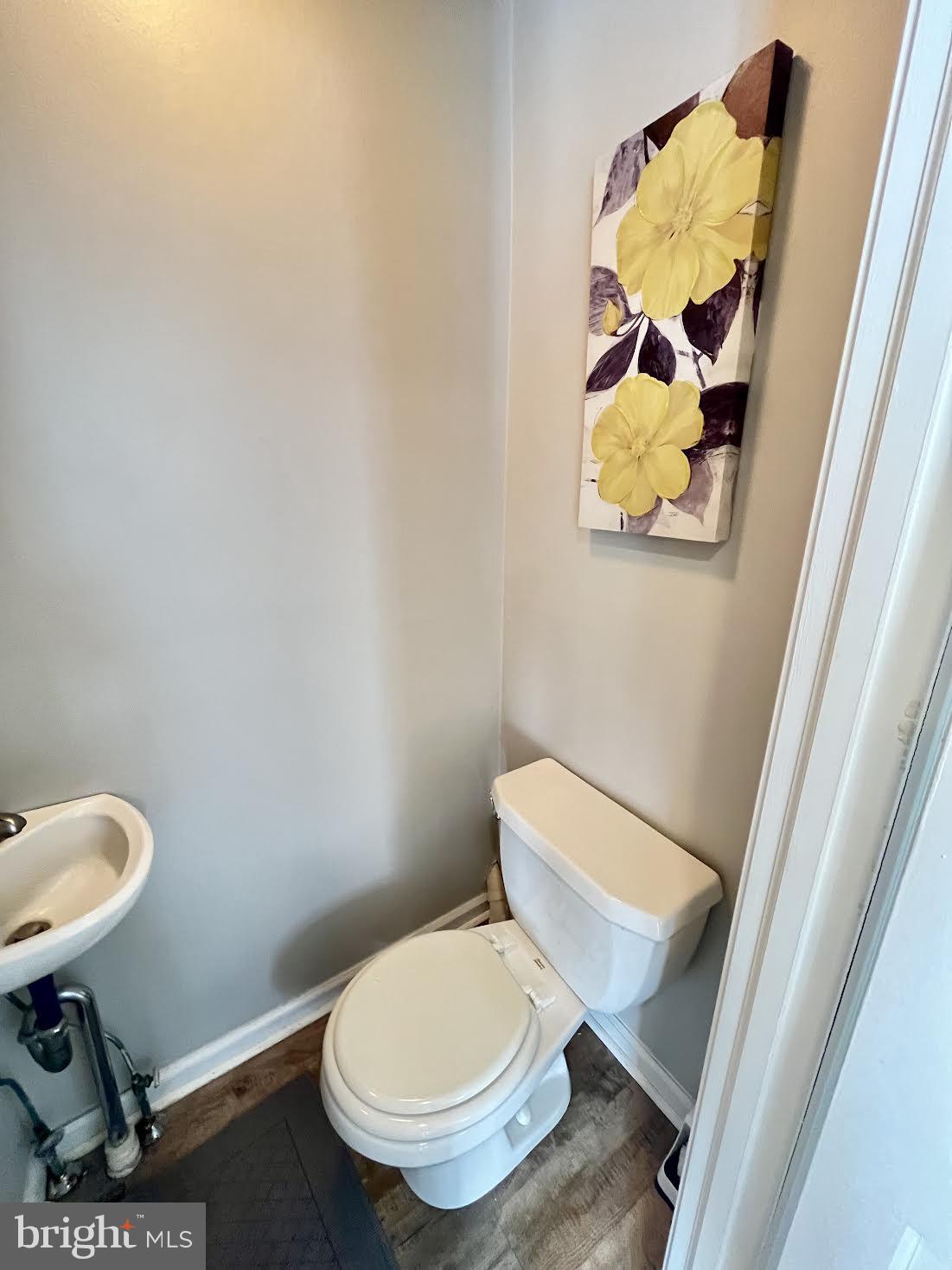 125 Maple Street Conshohocken, PA 19428 - Photo 5 of 32 a white toilet sitting next to a sink and a mirror