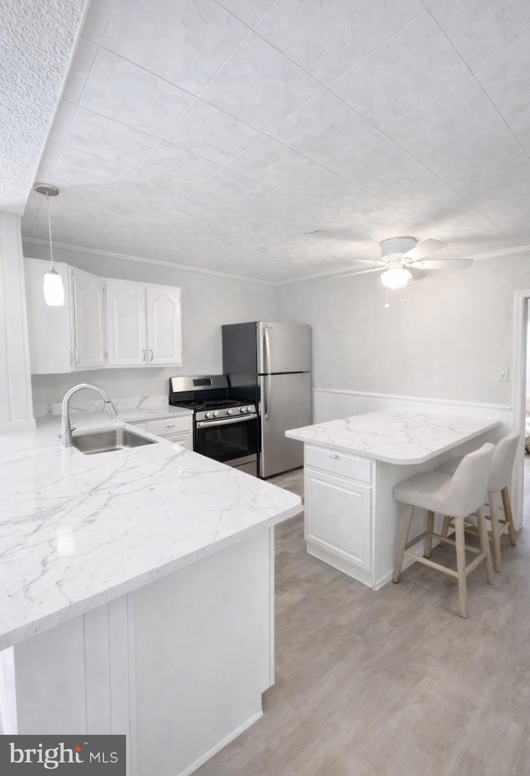 125 Maple Street Conshohocken, PA 19428 - Photo 5 of 20 a kitchen with a sink a table and chairs