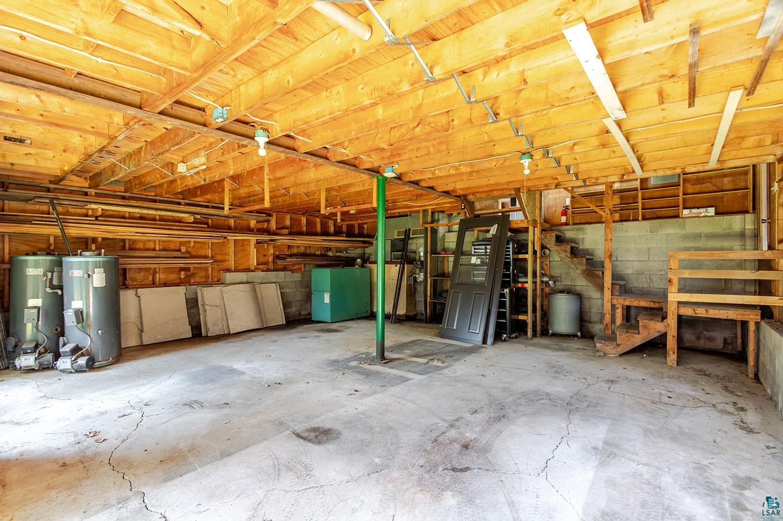29 Ridge Road Esko, MN 55733 - Photo 41 of 41 Garage space with exposed ceiling joists and concrete flooring