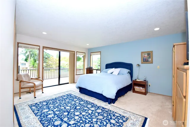 a bedroom with a bed and a large window