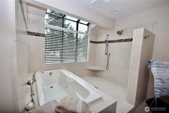 a bathroom with a tub sink and a shower