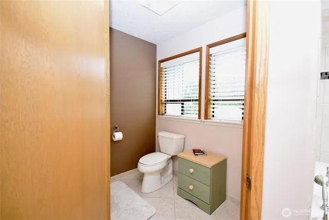 a bathroom with a toilet sink and a mirror