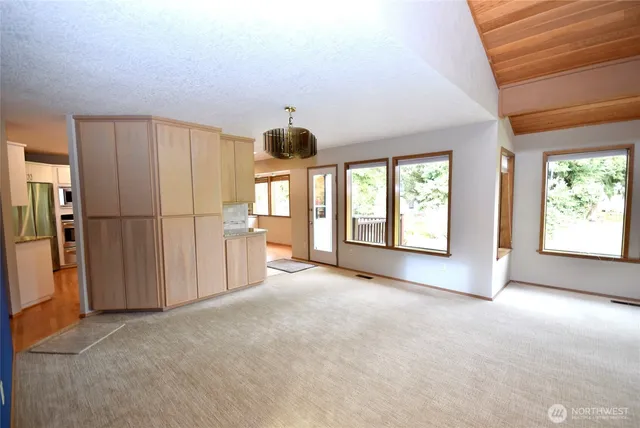 a view of an empty room with a fireplace and a window