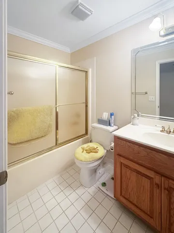 a bathroom with a granite countertop sink toilet a mirror and shower