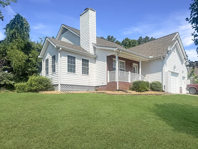 a front view of a house with a garden