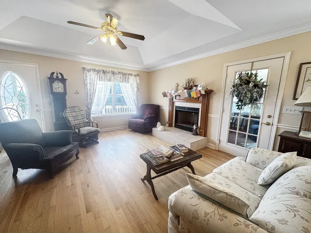 a living room with furniture fireplace and a window