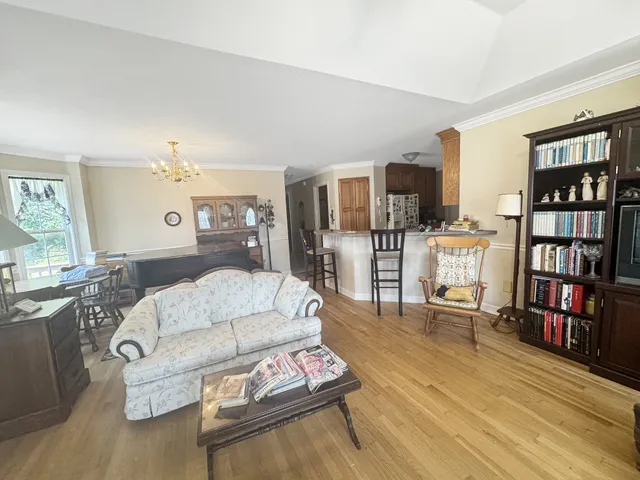 a living room with furniture and a book shelf
