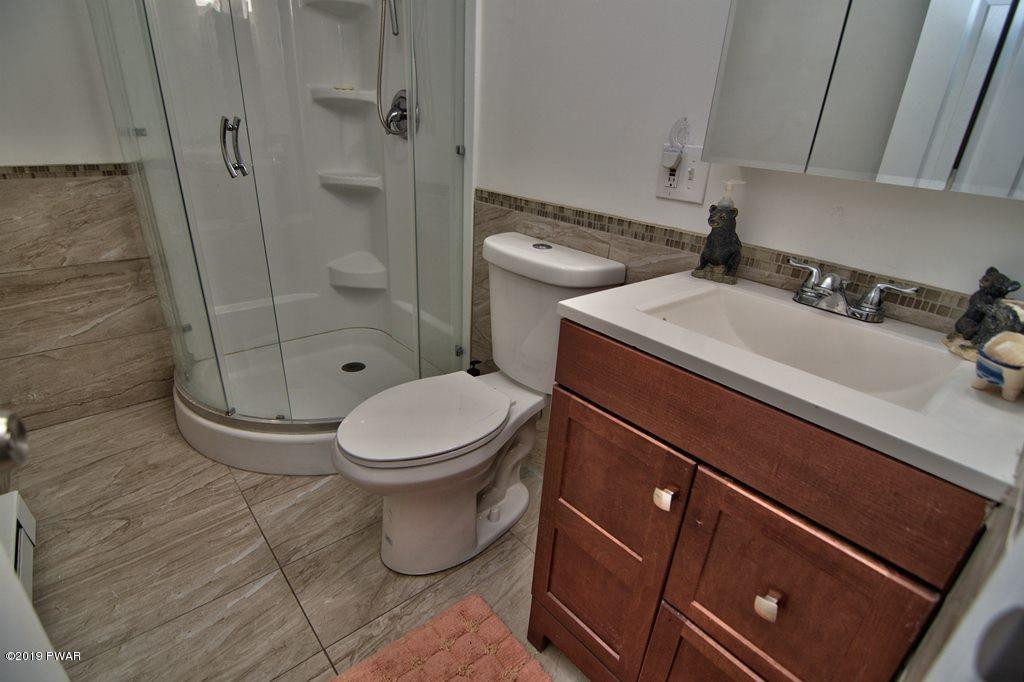 3145 Northgate Road Lake Ariel, PA 18436 - Photo 15 of 78 a bathroom with a granite countertop sink toilet and shower