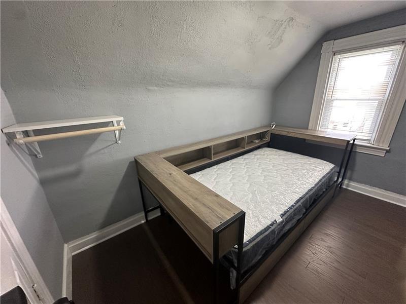 94 Lafferty Avenue Pittsburgh, PA 15210 - Photo 3 of 17 a bed sitting in a bedroom next to a window