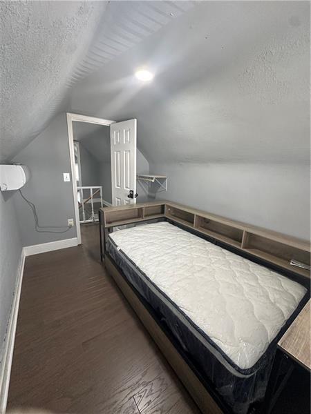 94 Lafferty Avenue Pittsburgh, PA 15210 - Photo 4 of 17 a bed sitting in a room next to a window