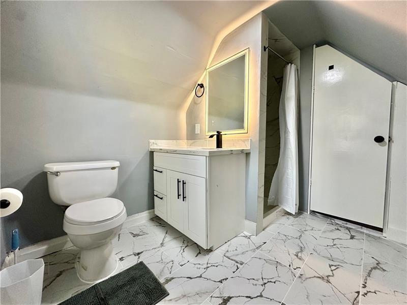 94 Lafferty Avenue Pittsburgh, PA 15210 - Photo 5 of 17 a bathroom with a sink toilet and shower